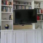 Bespoke sliding Bookcase open to reveal TV